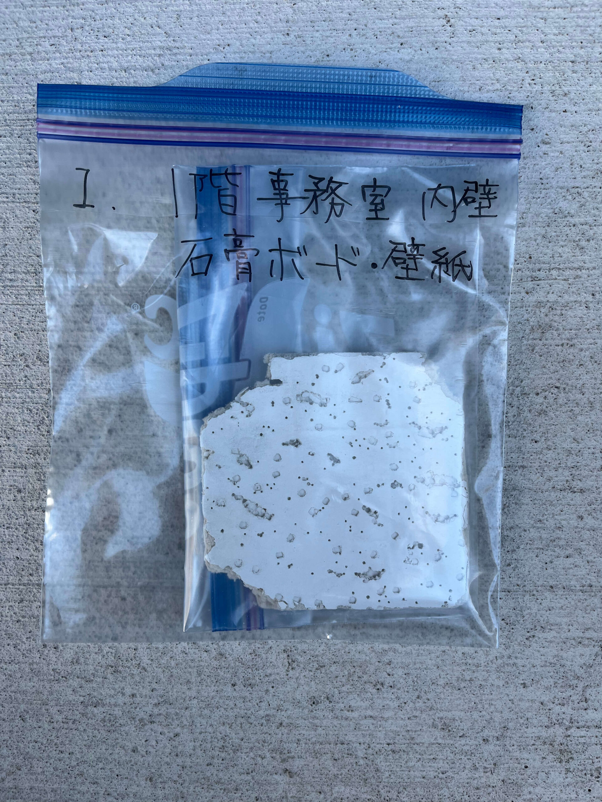 試料を入れた内袋を外袋に入れ、検体番号・採取箇所・建材名を表示した二重梱包の例